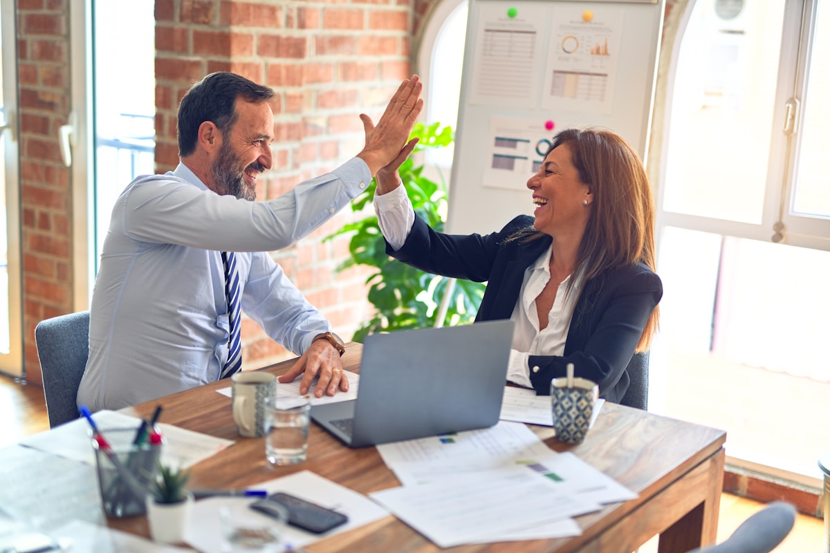 A CPA and a practice owner reviewing tax documents together at a table